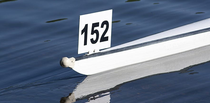 Racing boat shell competing in a competitive rowing race.