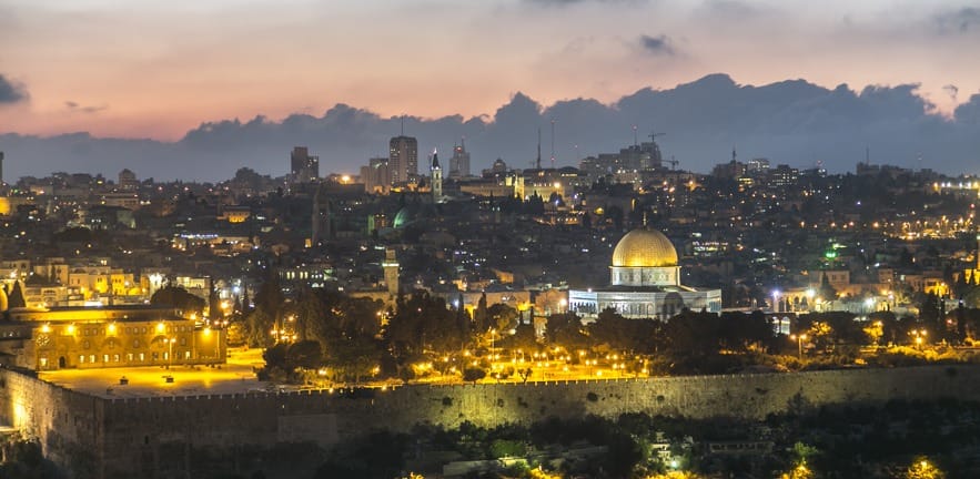 A long exposure shot at sunset of the old city of Jerusalem in Israel taken from the Mount of Olives. Showing the old temple mount of the Jews with the Dome of the Rock Mosque on top.