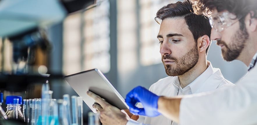 two scientist using digital tablet in laboratory