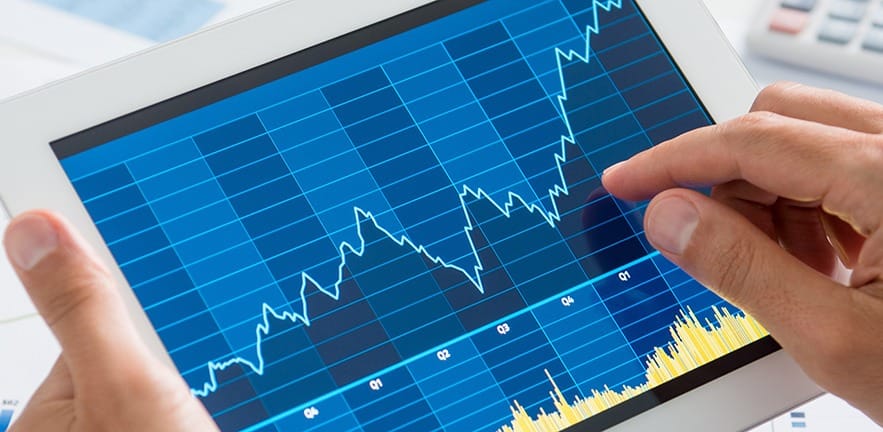 Close up of a business person analysing graph on digital tablet