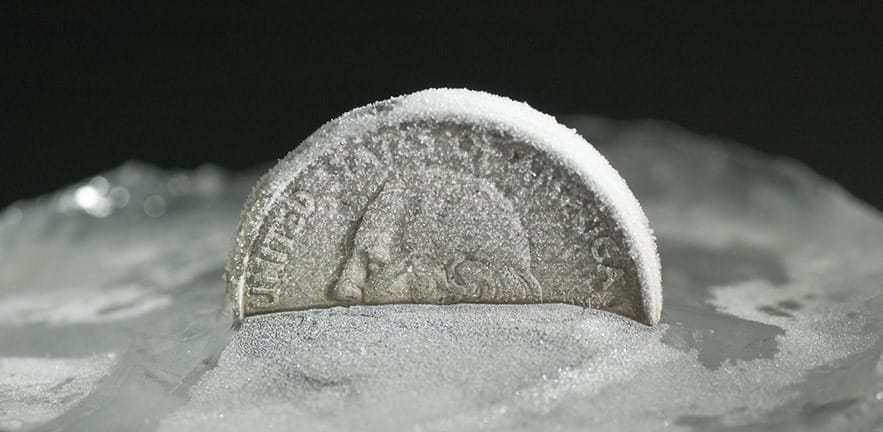 frozen money in the snow