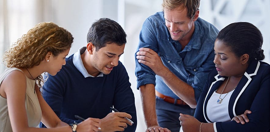 Shot of a group of colleagues working together in an office