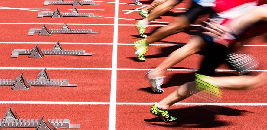 athletes in sprint start in track and field