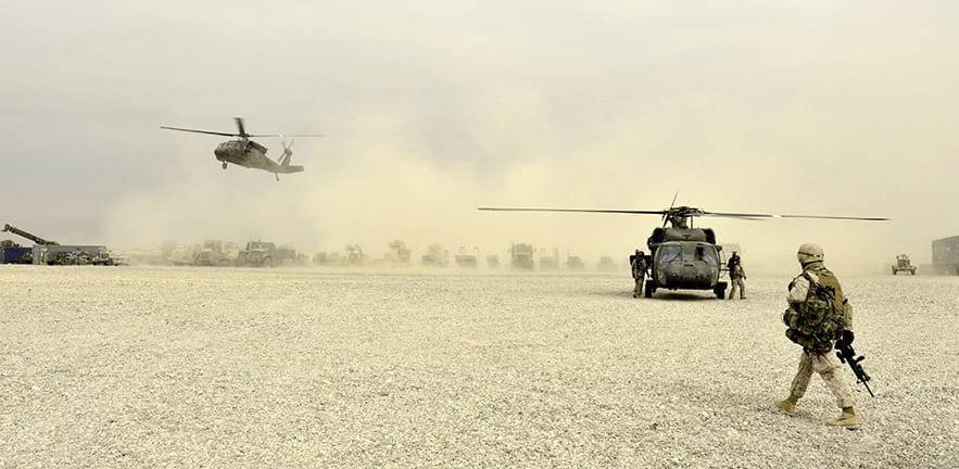 Marine in Afghanistan walks towards a helicopter