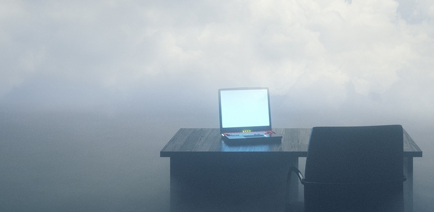 Computer in front of a foggy background.