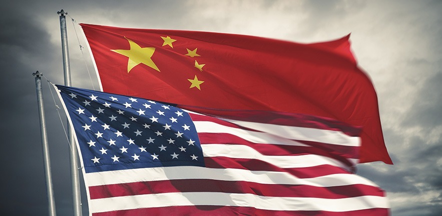 Chinese and United States flag waving together on stormy clouds background