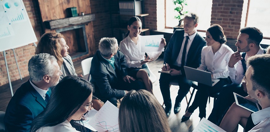 Nice stylish cheerful experts professional ceo boss chief sitting on chairs in circle showing financial plan result corporate conference at modern industrial loft interior room work place space.