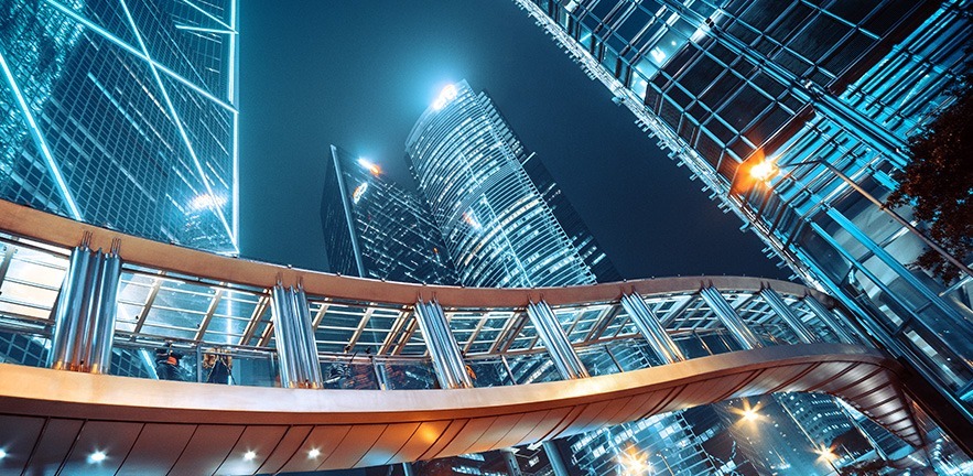 Footbridge and Modern office buildings in central Hong Kong at night