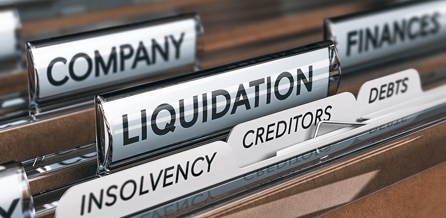 Company liquidation concept. File and tabs with the words insolvency, creditors and debts.