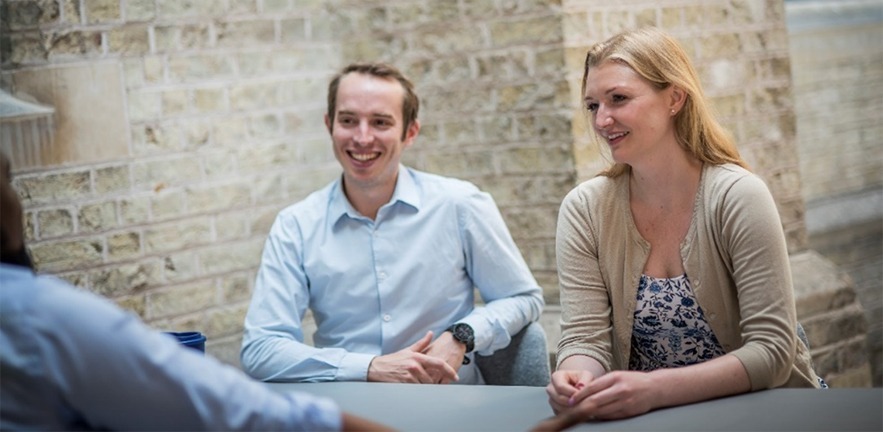 Cambridge MBA students having a discussion.