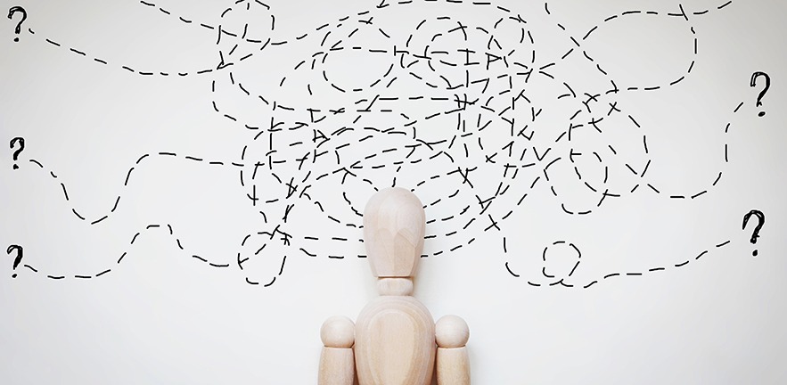 Abstract image with a wooden puppet - dotted lines and question marks.