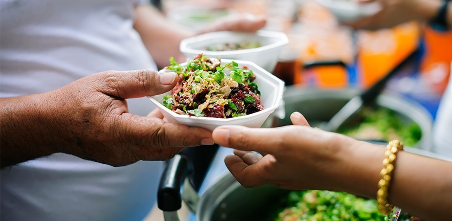 Image of volunteers serving food.