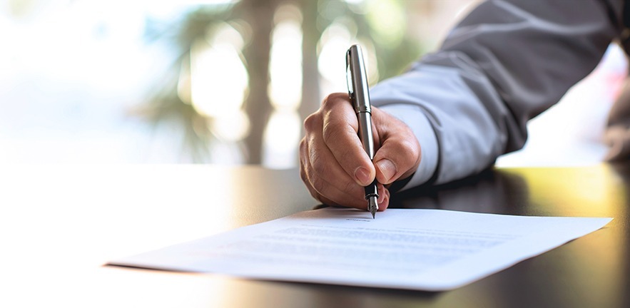 Businessperson signing an agreement.