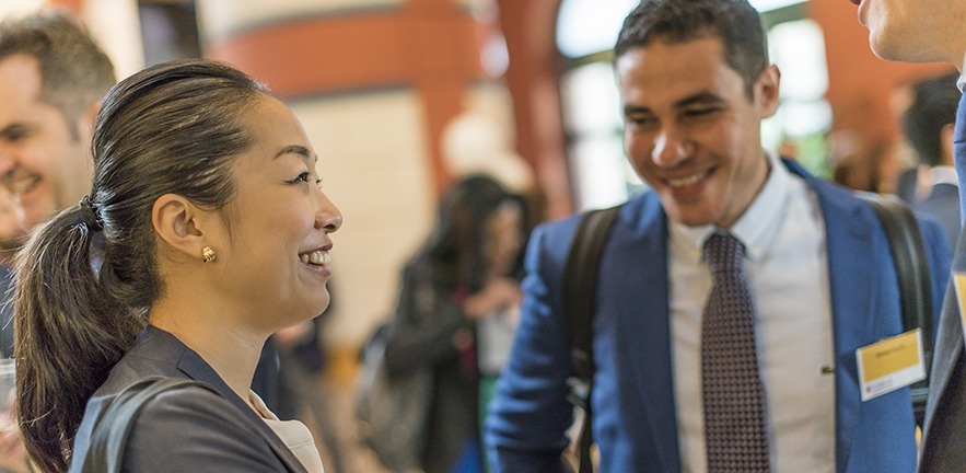 Female MBA candidate introducing herself to others on an MBA interview day.