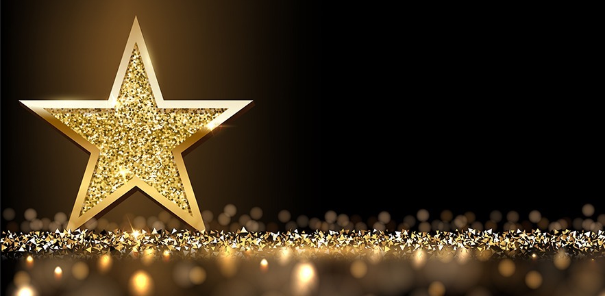 Golden sparkling star isolated on dark luxury horizontal background.