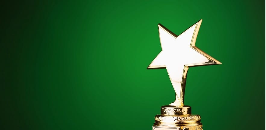 Gold star trophy on green background picture id498910476