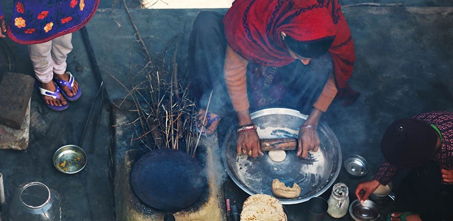 Rural women making chapatti on Wood burning stove.
