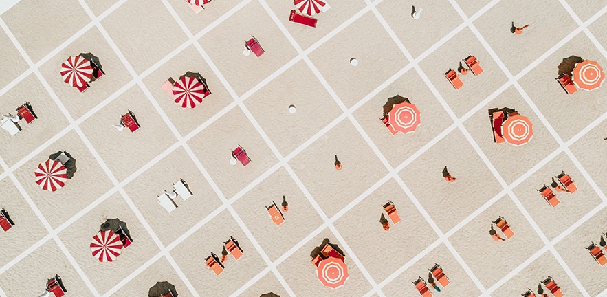 Aerial view of the beach divided in squares for social distancing.