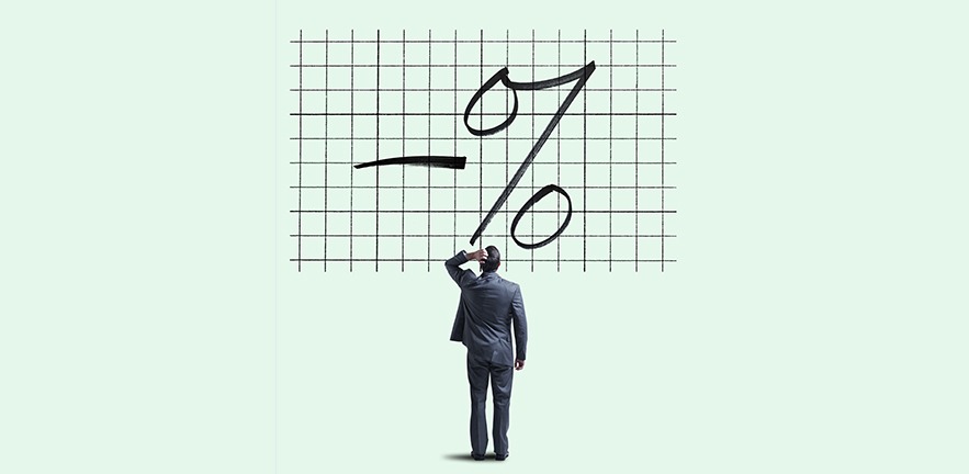 A businessman places his hand on his head as he looks up and is perplexed by a chart showing a negative interest rate.