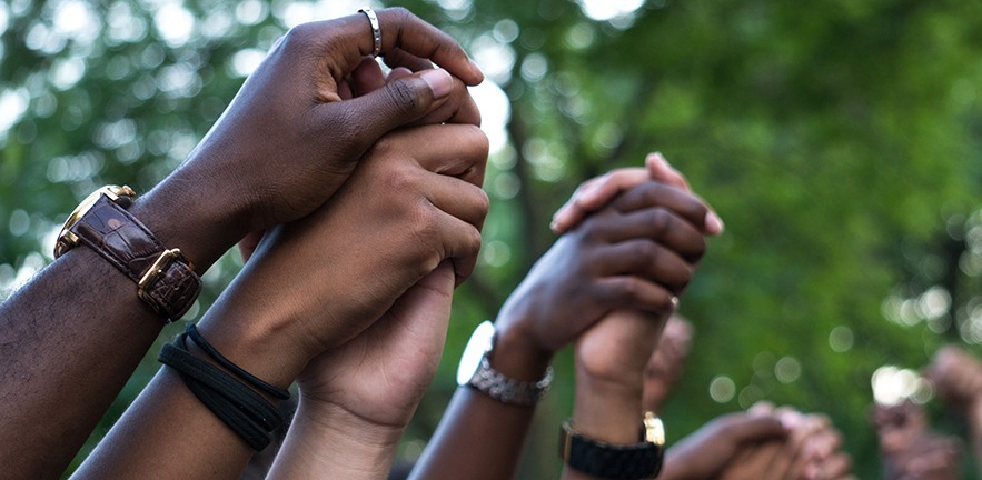 Hands clasped in solidarity.