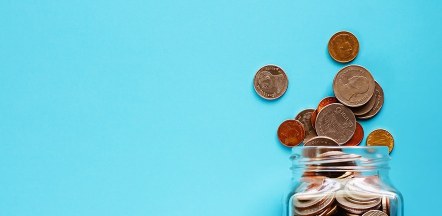 Photo of pennies falling out of a jar.