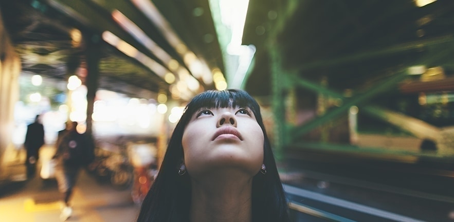 Woman looking up thinking.