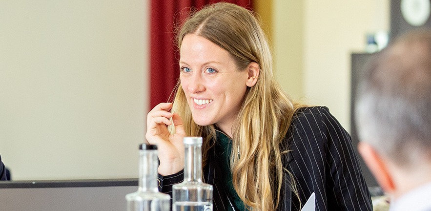 A smiling Executive Education female delegate.