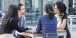 Students enjoying a conversation in the courtyard.