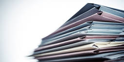 A stack of pastel-coloured folders.