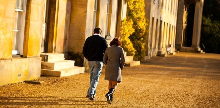 two students walk through Downing College