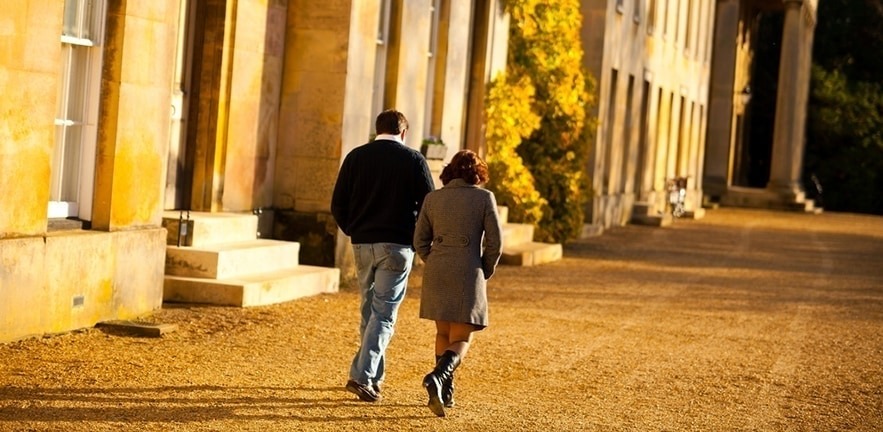 two students walk through Downing College