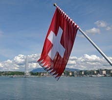 Flag of Switzerland flying over Lake Geneva.