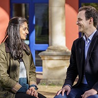 CJBS PhD students having a chat on the front lawn