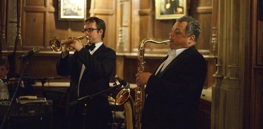 People playing instruments in one of the Cambridge Colleges.