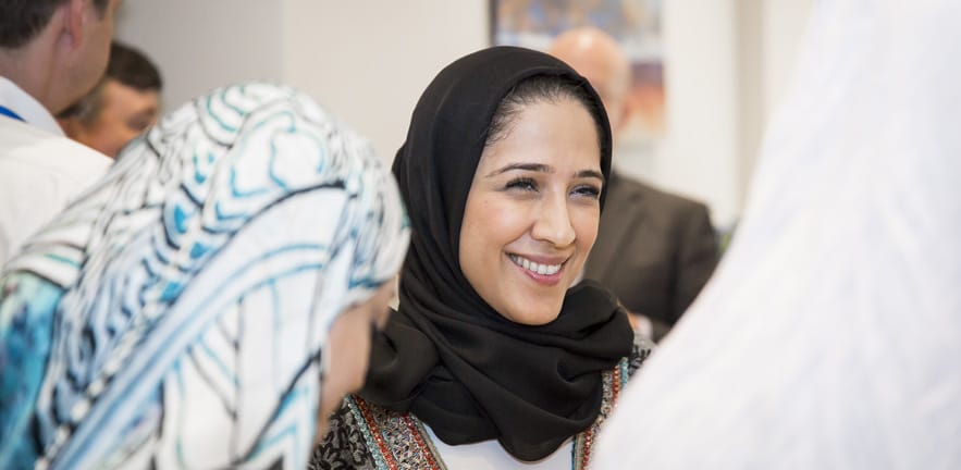 A smiling female delegate.