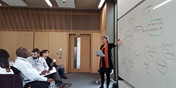 Professor Yasemin Kor points to something on the whiteboard in front of the class.