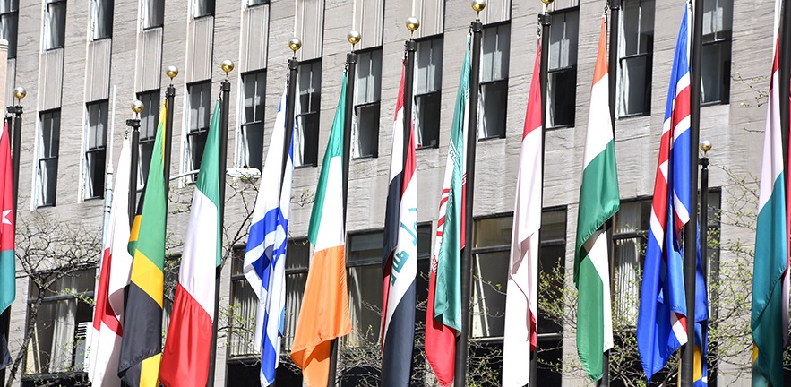 Skyscraper with world flags at the entrance.
