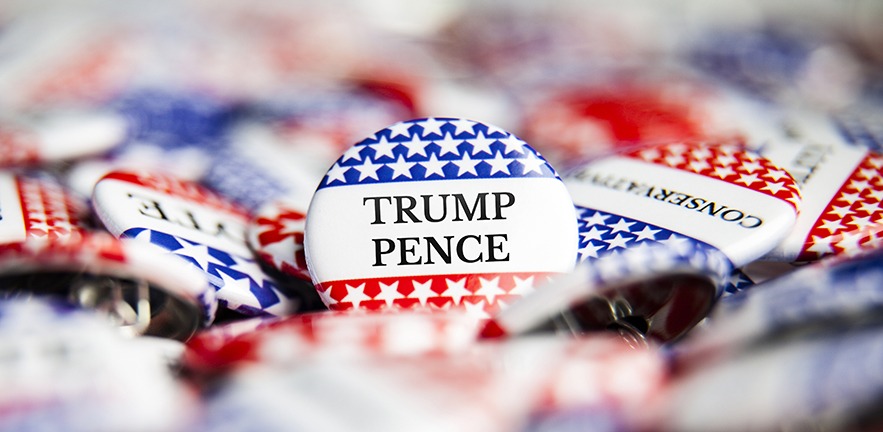 A pile of Trump/Pence election campaign badges.
