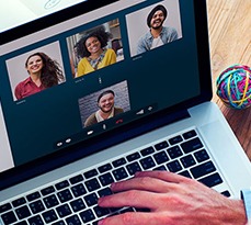 Laptop showing a video chat with a few different people.