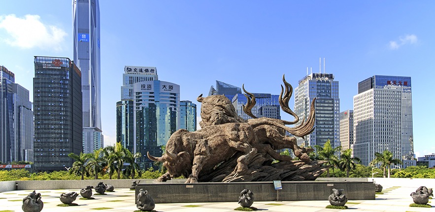 The stock market building in Shenzhen, with a copper sculpture of a bull in the foreground.