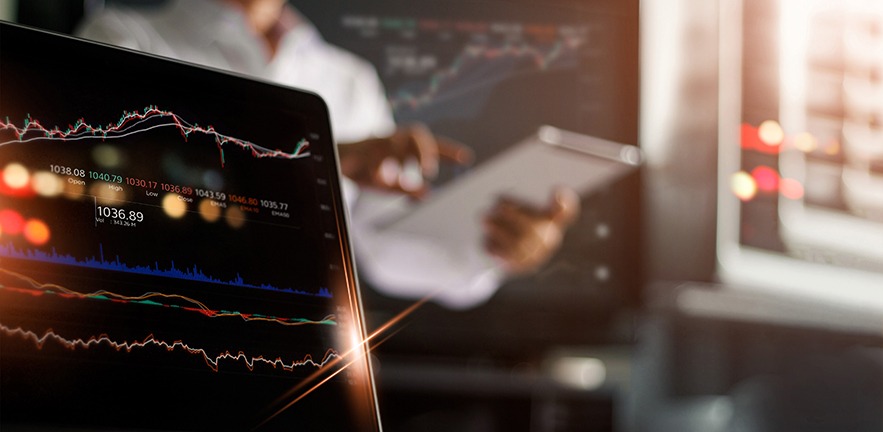 Business person using tablet and analysing stock exchange online in monitoring room background, forex trading graph, stock market and financial investment concept.