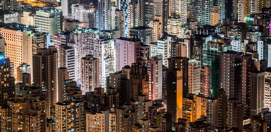 Buildings lit up at night on the Kowloon Peninsula on Hong Kong.