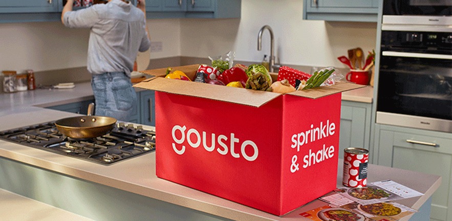 A kitchen counter with a freshly opened Gousto meal box on top.