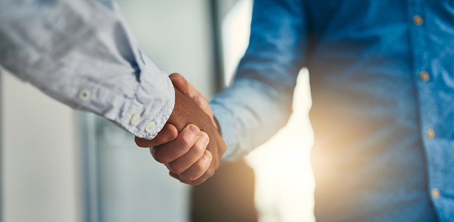 Closeup shot of businesspeople shaking hands.