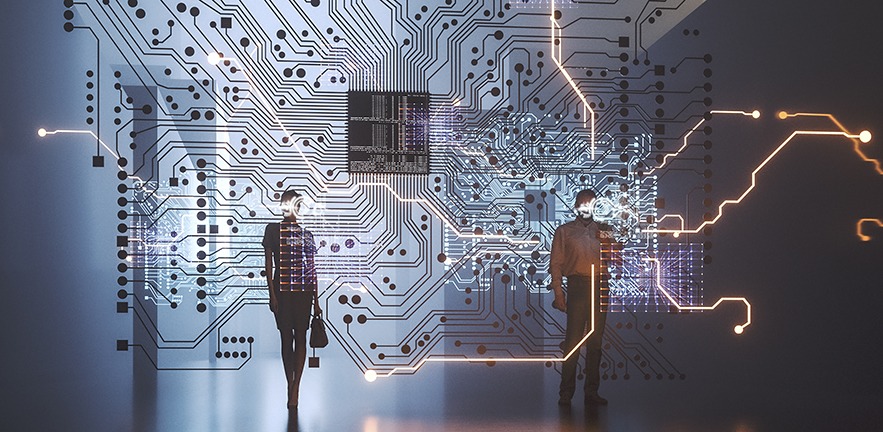 Silhouettes of a man and a woman standing in front of a transparent computer chip.