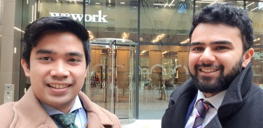 Daeng Termizi and Areeb Siddiqui standing outside a London office.