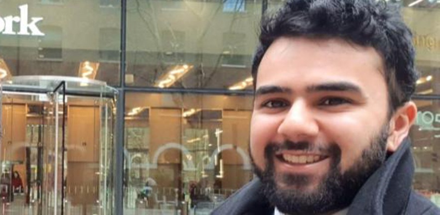 Areeb Siddiqui standing outside a London office.