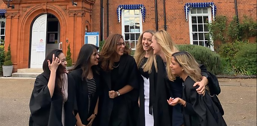 A group of happy female MBA students at their graduation ceremony.