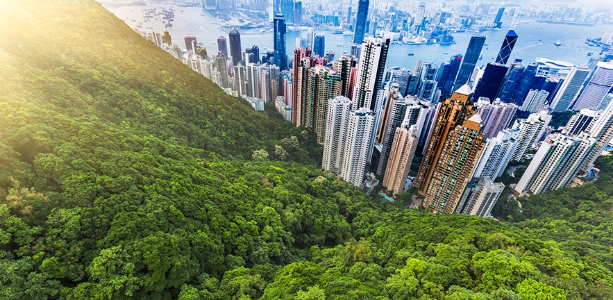 View of Hong Kong and Victoria Harbour at sunset, showing the surrounding nature.