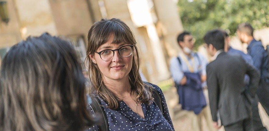 MBA student looks intently as she listens to a fellow classmate.